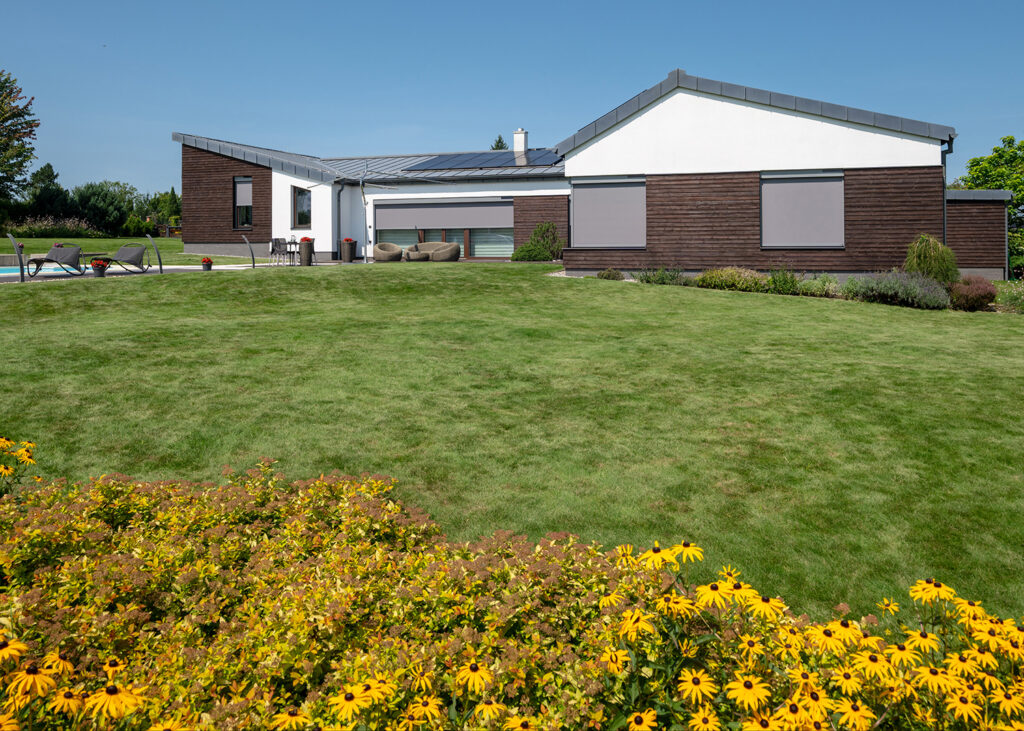 Moderný dom s veľkým trávnikom a s creenovými roletami NEVA
